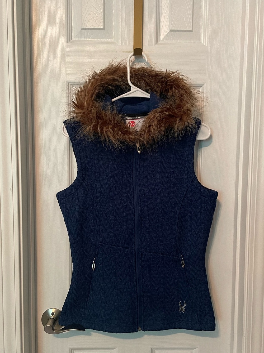 Spyder Women's Hoody Cable Core Sweater Vest with a faux fur hood trim.